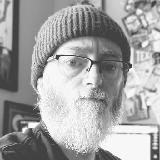 Portrait of Rik Catlow, illustrator and artist, wearing glasses and a beanie